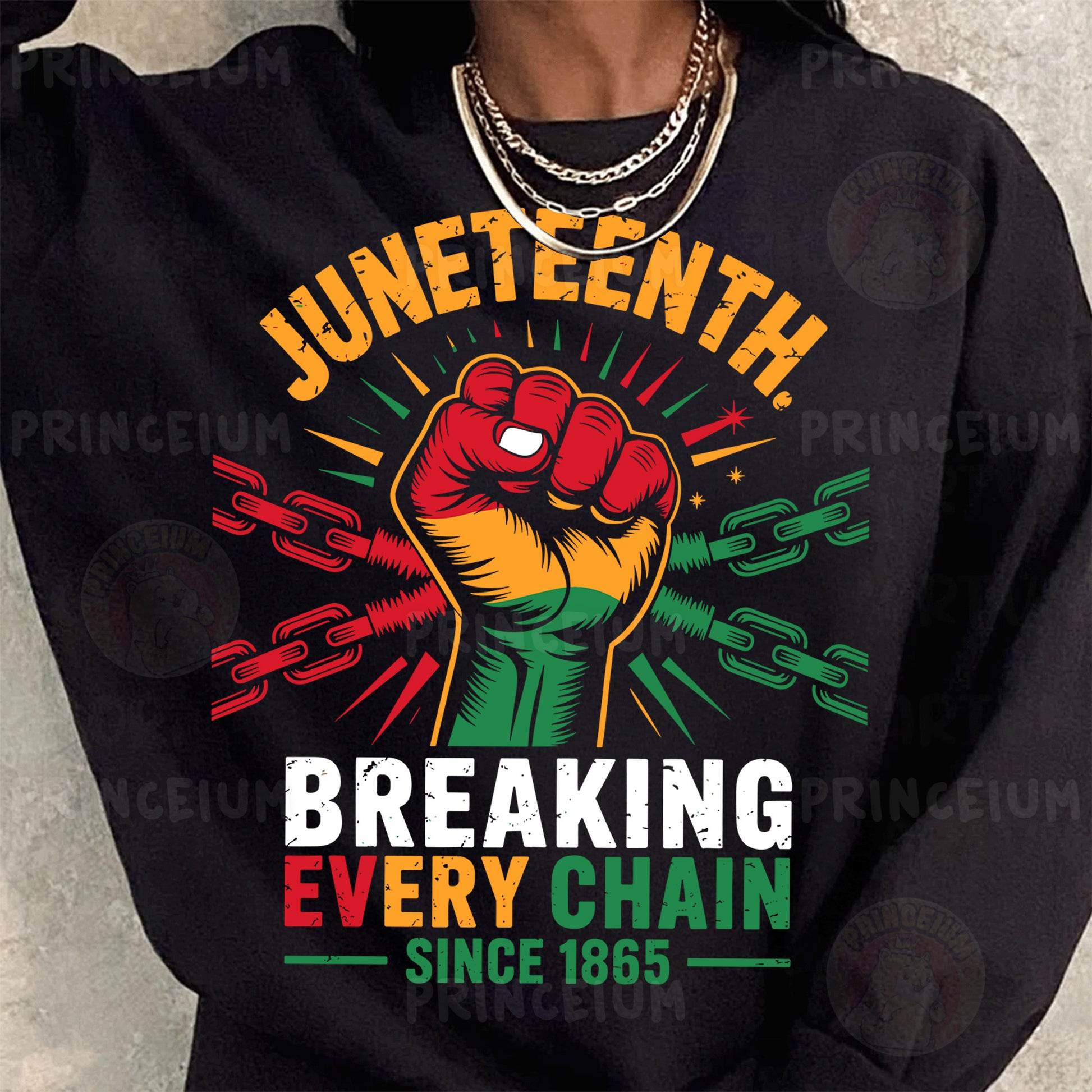 a woman wearing a black sweatshirt with a fist on it