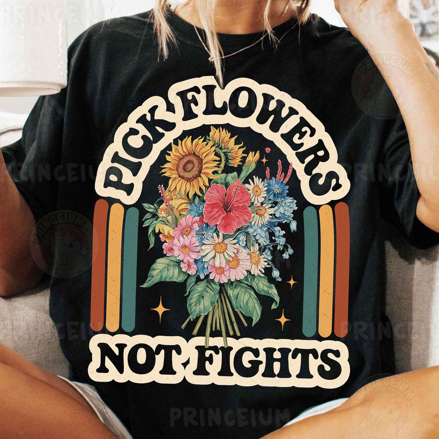 a woman sitting on a couch wearing a black flower t - shirt