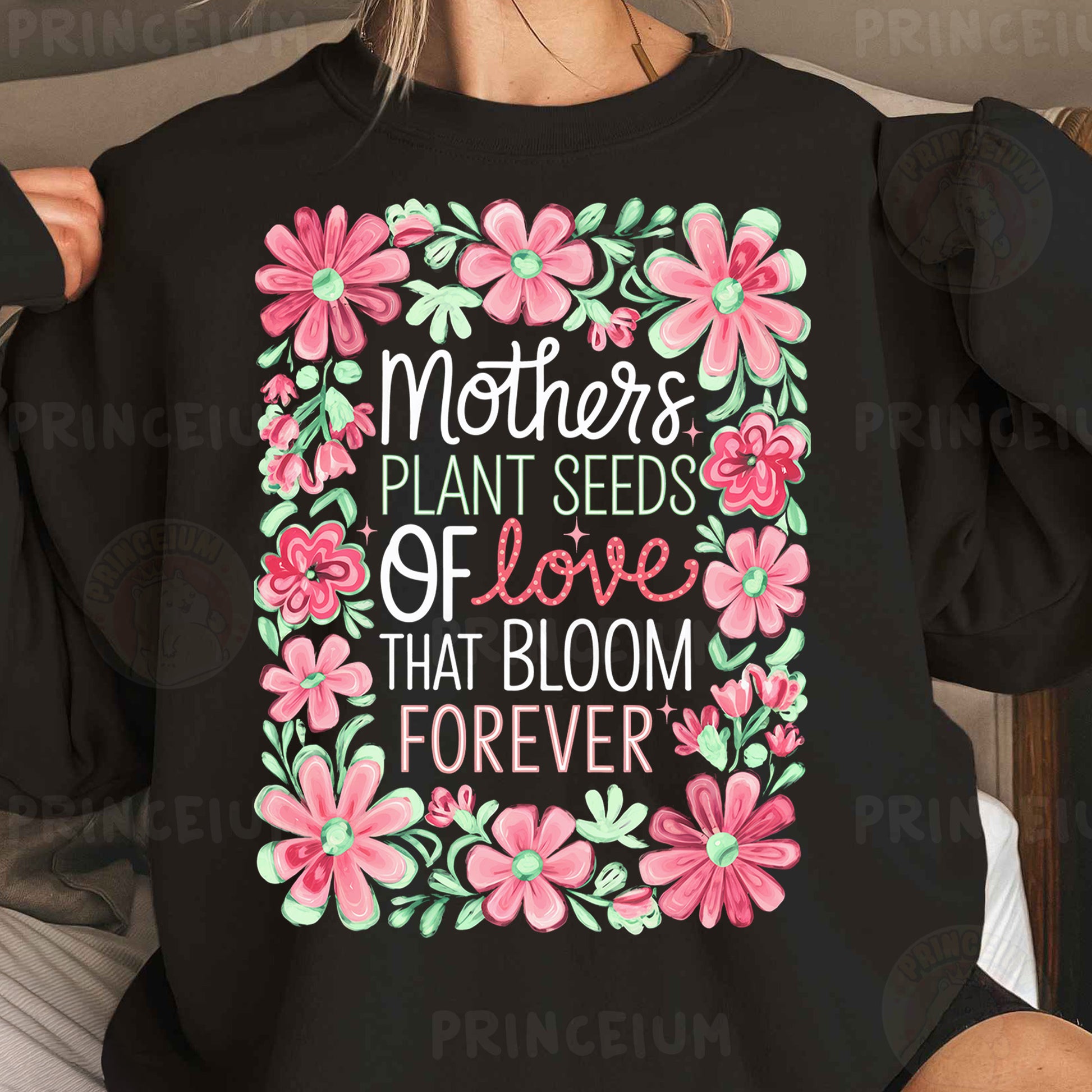 a woman wearing a black shirt that says mothers plant seeds of love that bloom forever