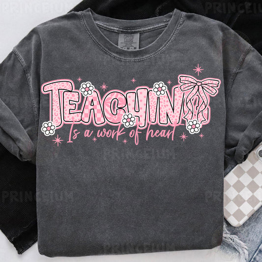 a t - shirt that says teaching is a work of heart
