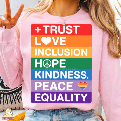a woman wearing a pink shirt that says trust, love, inclusion, hope