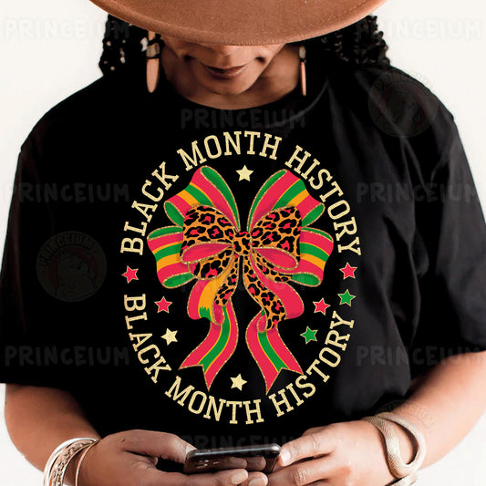 a woman wearing a black t - shirt with a red, green, and yellow