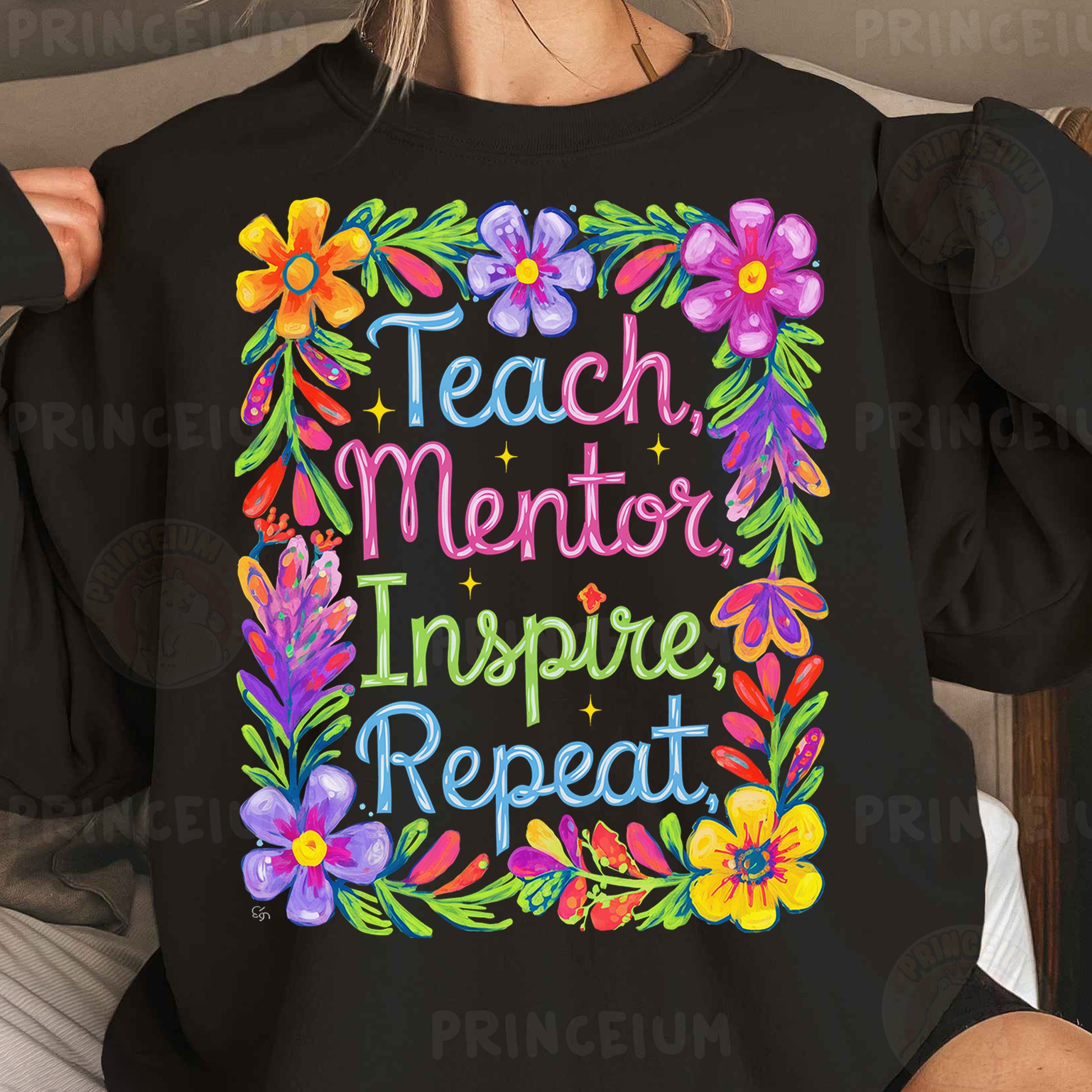 a woman wearing a black sweatshirt that says teach mentor inspire repeat