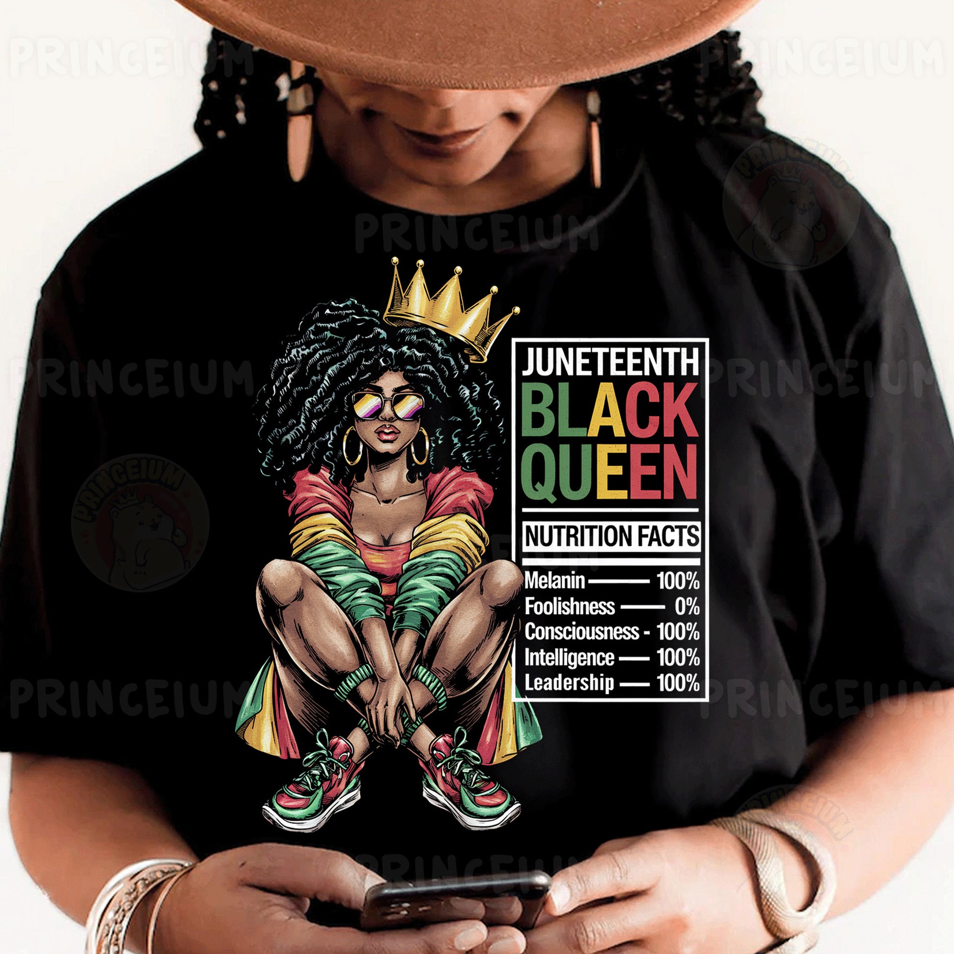 a woman wearing a black queen shirt holding a cell phone