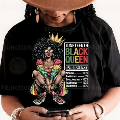 a woman wearing a black queen shirt holding a cell phone