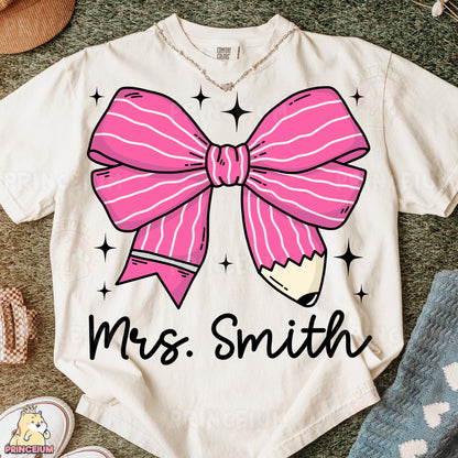 a white shirt with a pink bow on it