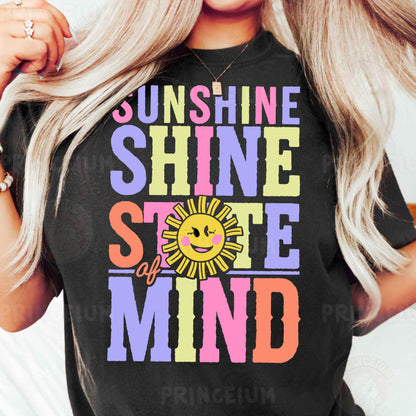 a woman with blonde hair wearing a black sunshine shirt