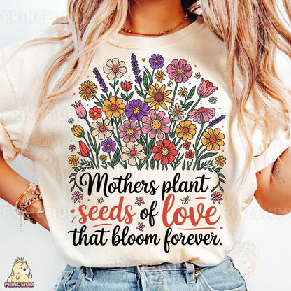 a woman wearing a t - shirt that says mothers plant seeds of love that bloom