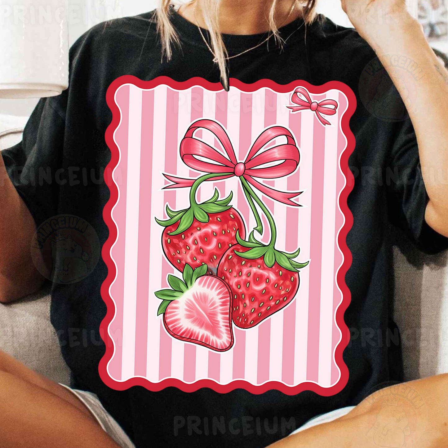 a woman sitting on a couch wearing a t - shirt with a picture of two