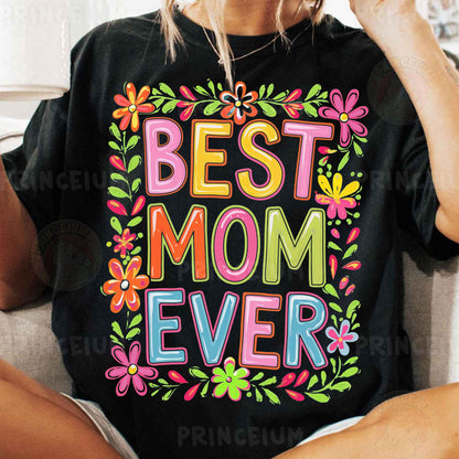 a woman sitting on a couch wearing a t - shirt that says best mom ever