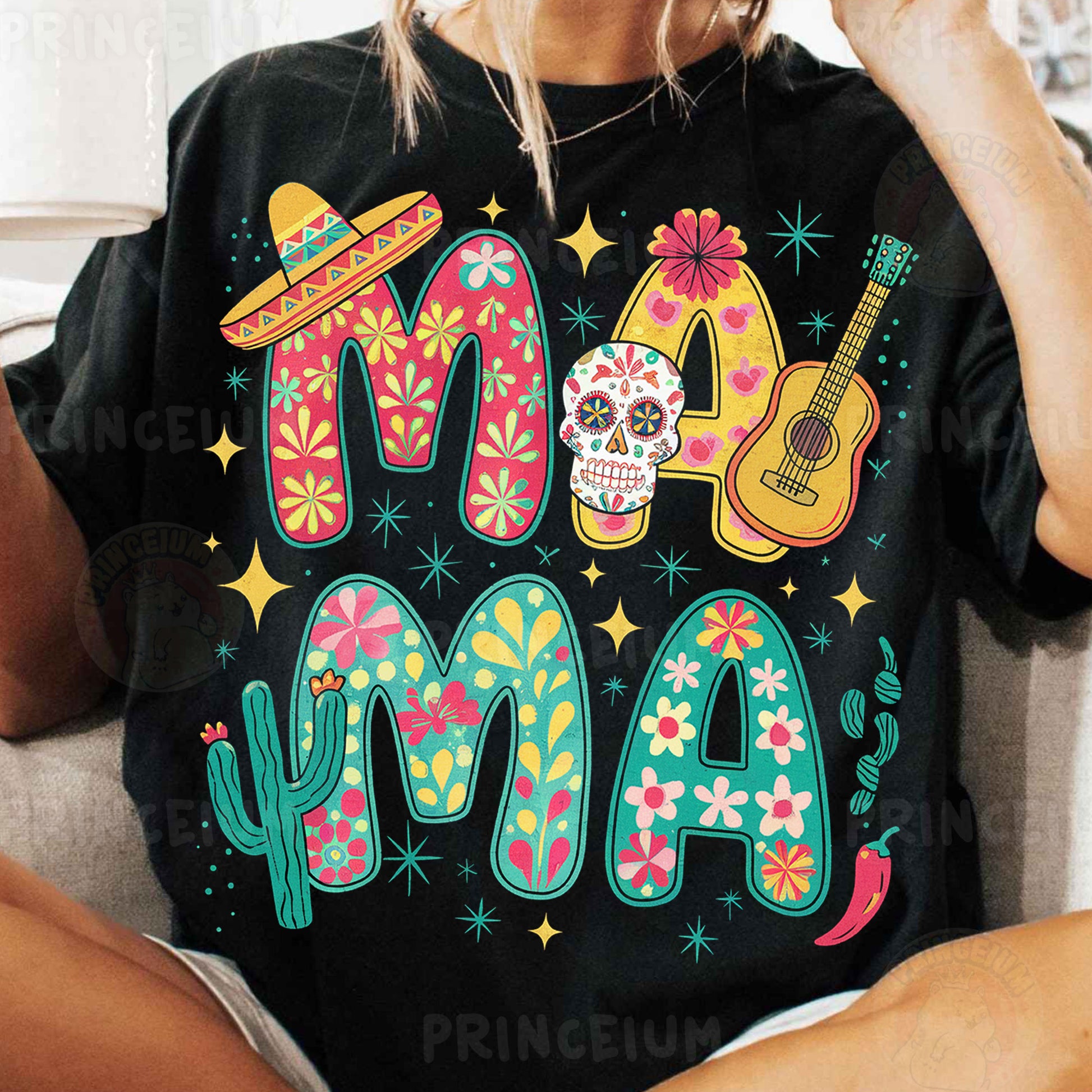 a woman sitting on a couch wearing a black shirt that says mama