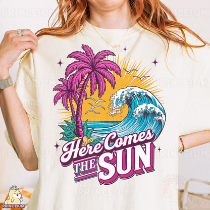 a woman wearing a t - shirt that says here comes the sun