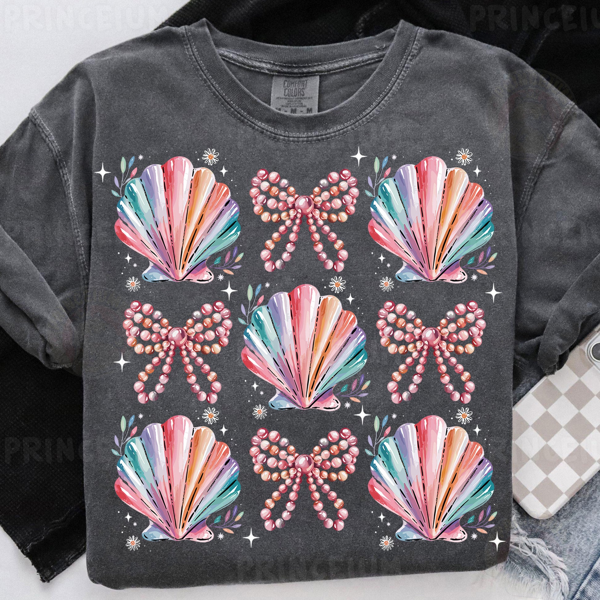a t - shirt that has a bunch of seashells on it