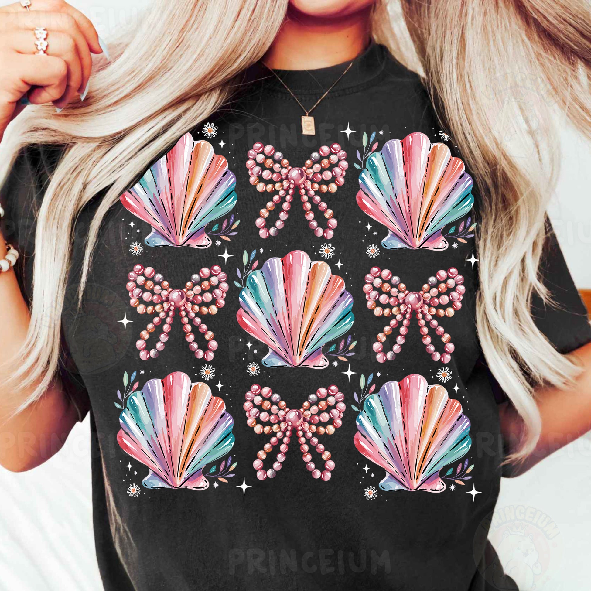a woman with blonde hair wearing a black t - shirt with colorful seashells