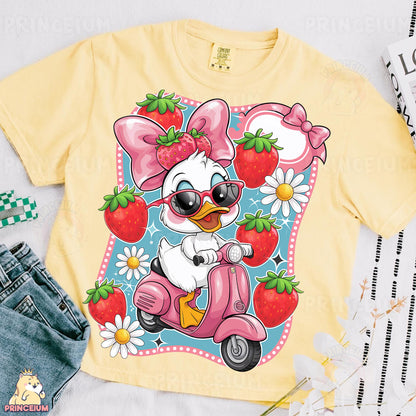 a t - shirt with an image of a duck riding a scooter