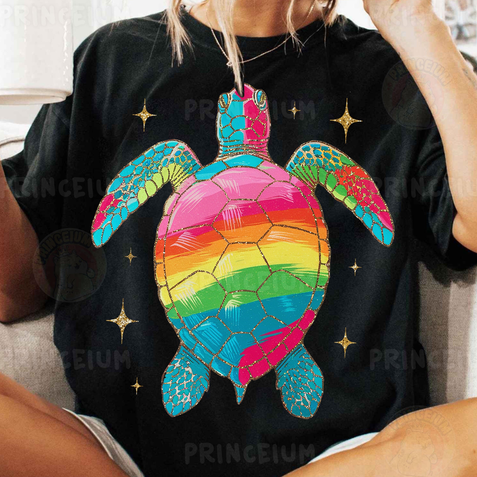 a woman sitting on a couch wearing a t - shirt with a turtle on it