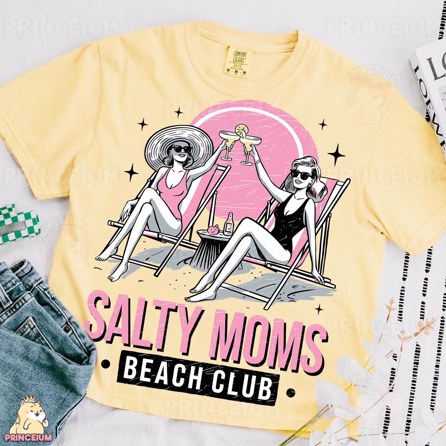 a yellow t - shirt with a picture of two women sitting on beach chairs