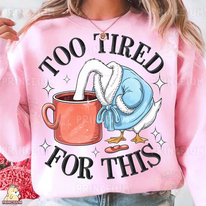 a woman wearing a pink sweatshirt with a coffee mug printed on it