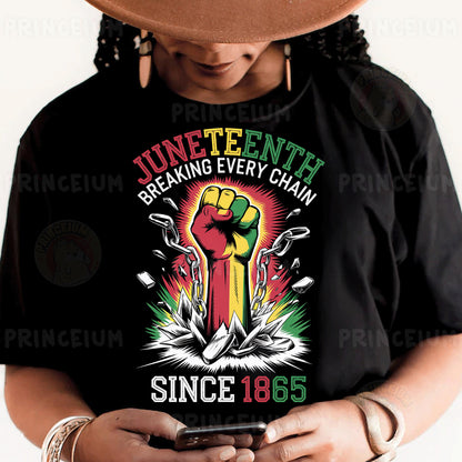 a person wearing a black shirt and a hat holding a cell phone