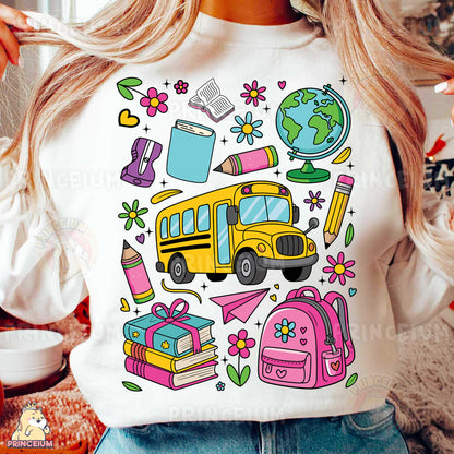 a woman wearing a t - shirt with school supplies on it