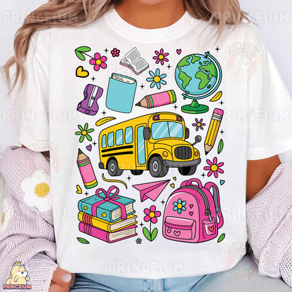 a woman wearing a white t - shirt with school supplies on it