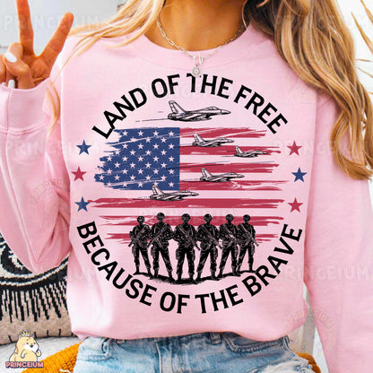 a woman wearing a pink shirt that says land of the free because of the brave