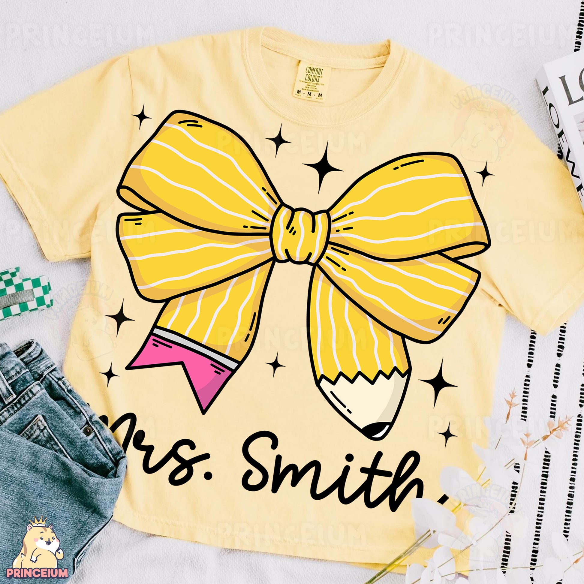 a t - shirt with a pencil and a bow on it