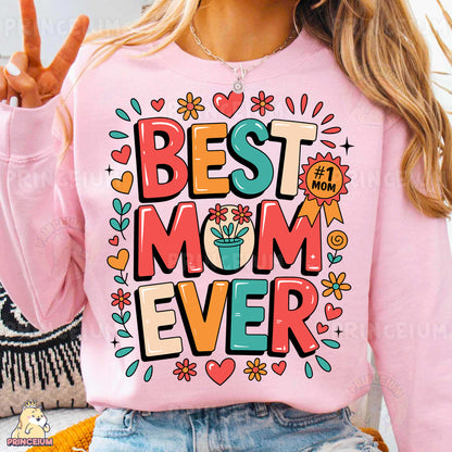 a woman wearing a pink sweatshirt with the words best mom ever on it