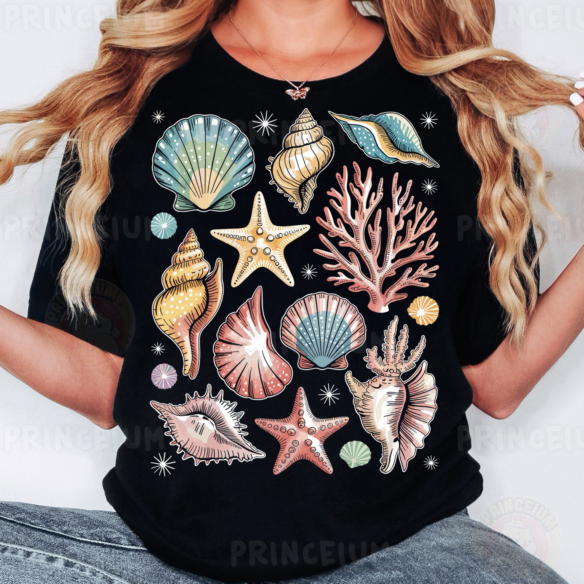 a woman wearing a black t - shirt with seashells on it