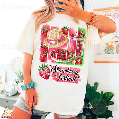 a woman taking a selfie while wearing a strawberry festival shirt