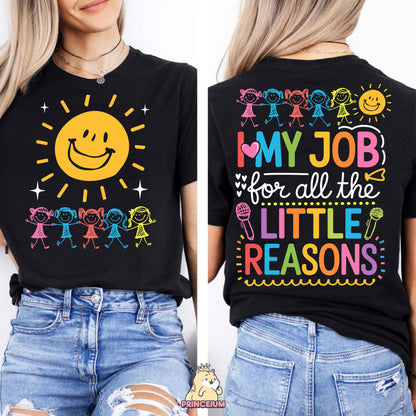 a woman wearing a black shirt with a smiley face on it