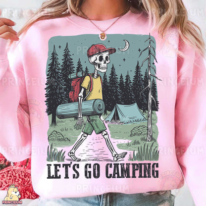 a woman wearing a pink sweatshirt with a skeleton carrying a barrel