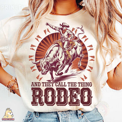 a woman wearing a rodeo t - shirt with a cowboy riding a horse
