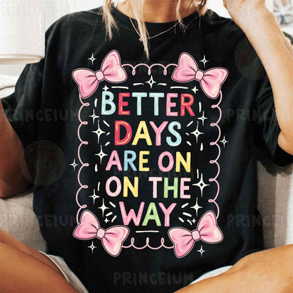 a woman sitting on a couch wearing a t - shirt that says better days are