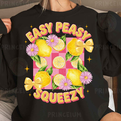 a woman wearing a black sweatshirt with lemons and daisies on it