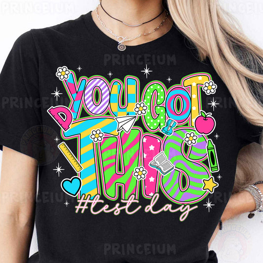 a woman wearing a black tshirt that says you got this festive