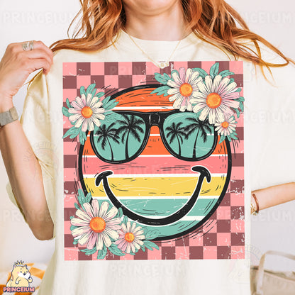 a woman wearing a t - shirt with a picture of a smiley face wearing sunglasses