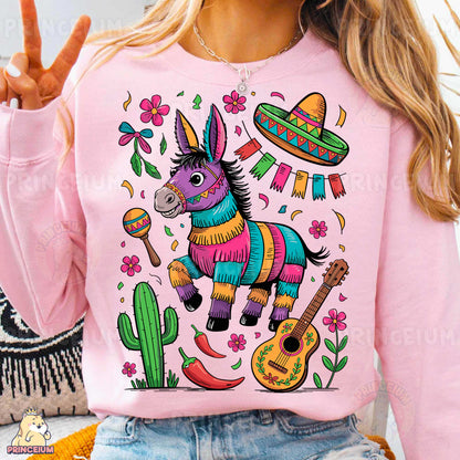 a woman wearing a pink sweater with a mexican donkey on it