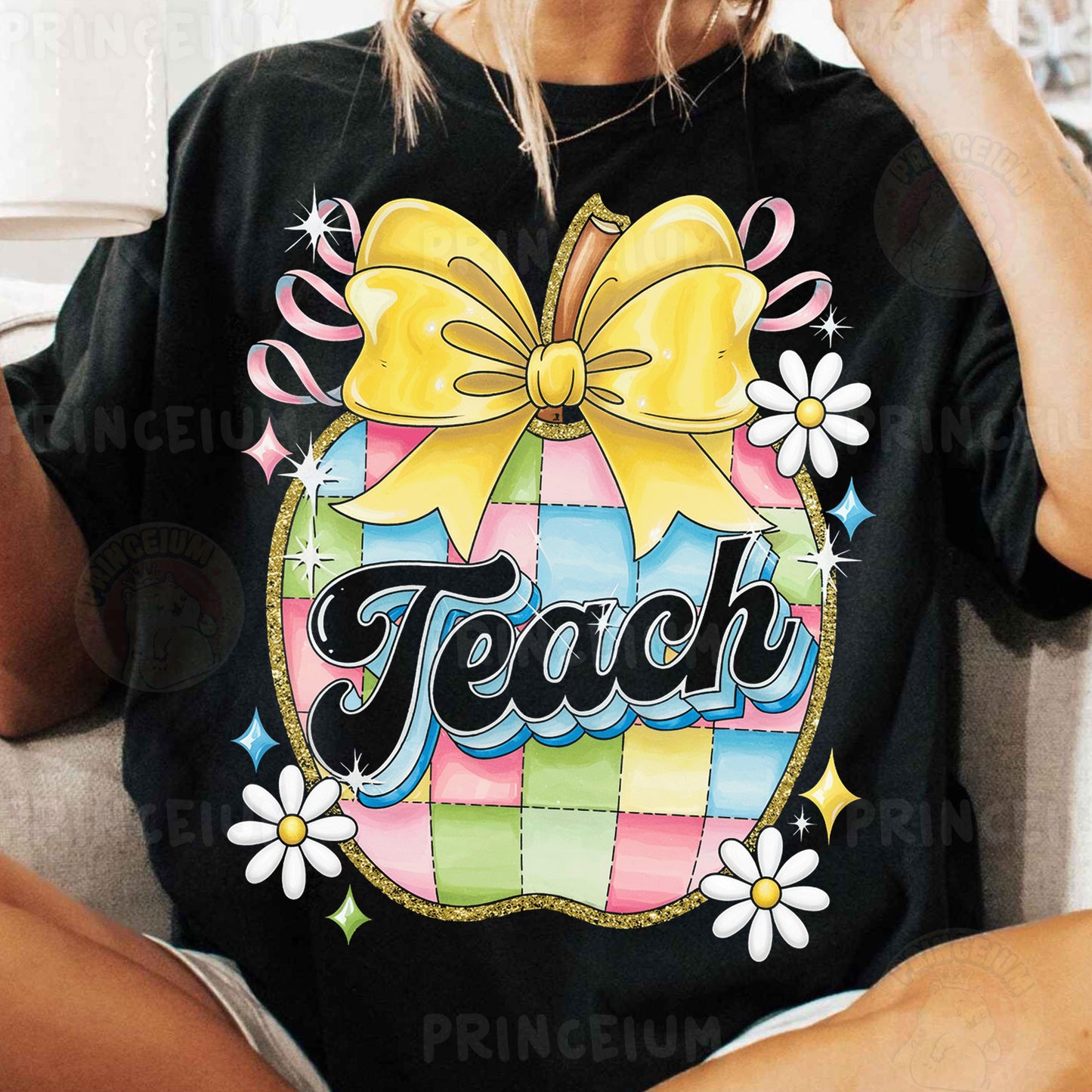 a woman sitting on a couch wearing a black shirt with a yellow bow