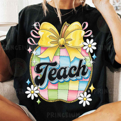 a woman sitting on a couch wearing a black shirt with a yellow bow