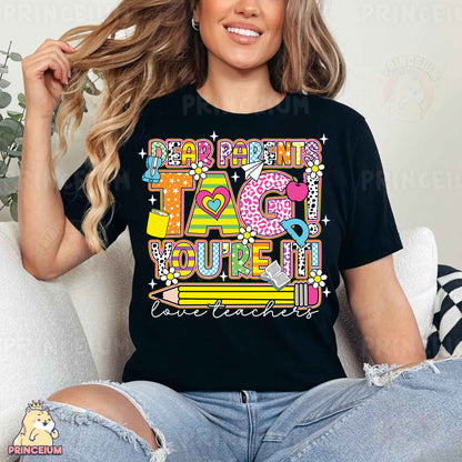 a woman sitting on a couch wearing a black t - shirt