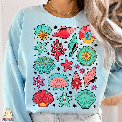 a woman wearing a blue sweatshirt with colorful sea life on it