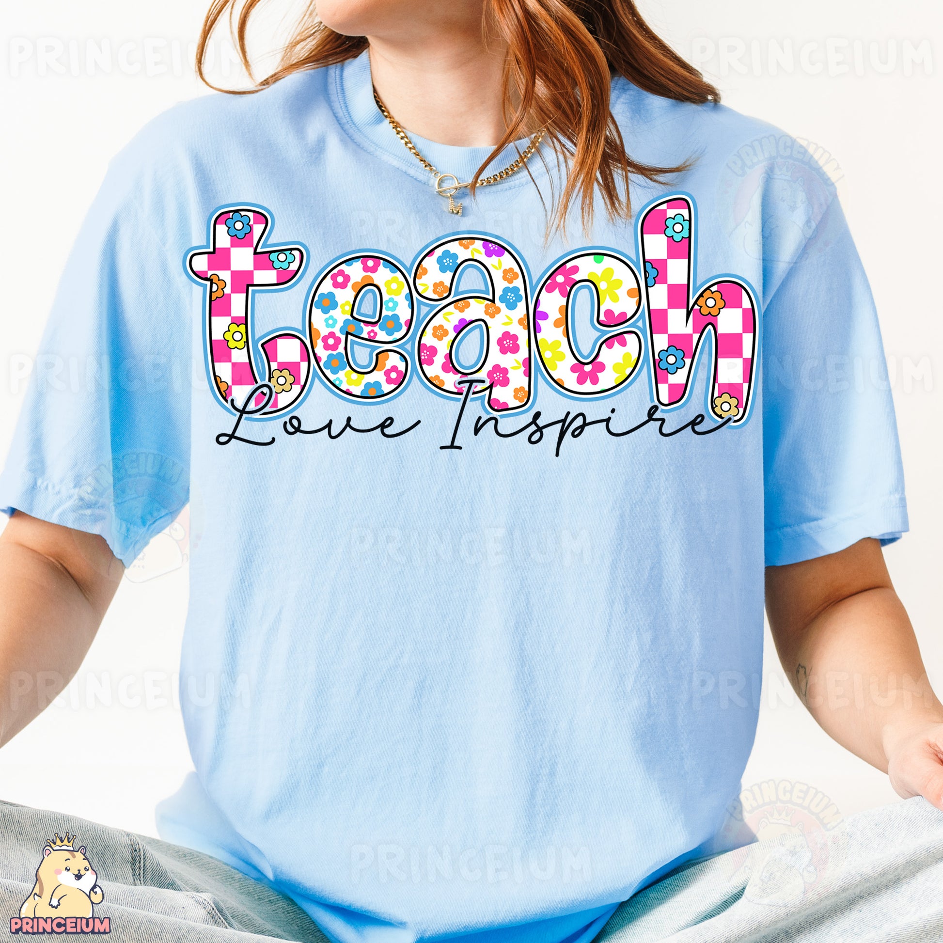 a woman wearing a light blue shirt with the word teach printed on it