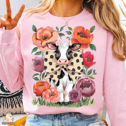 a woman wearing a pink sweater with a cow on it