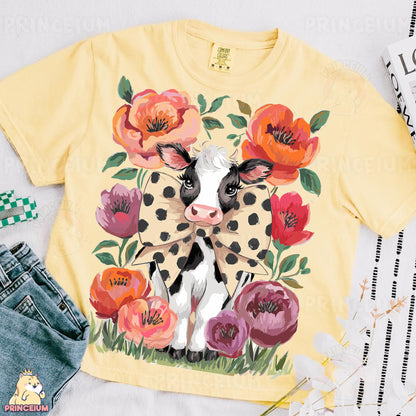 a yellow shirt with a cow and flowers on it