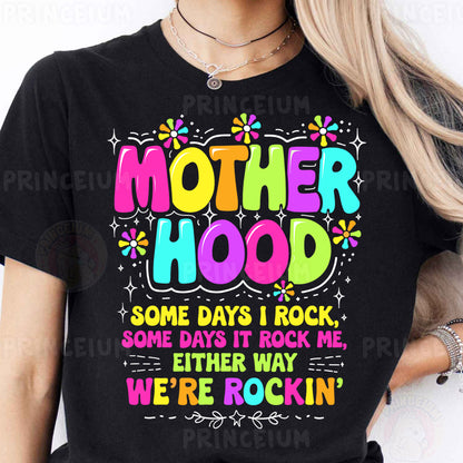 a woman wearing a black t - shirt that says motherhood some days i rock