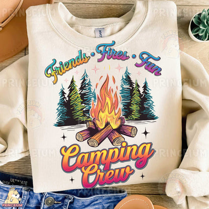 a white shirt with a campfire and trees on it