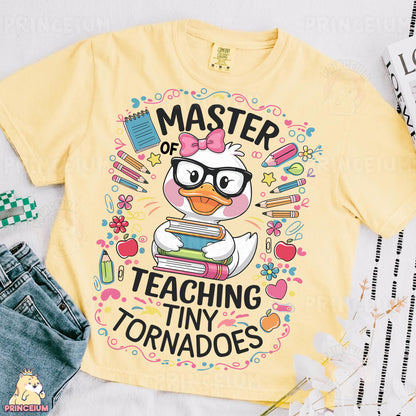 a yellow t - shirt with a cartoon duck reading a book