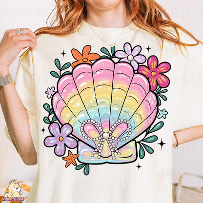 a woman wearing a t - shirt with a seashell on it