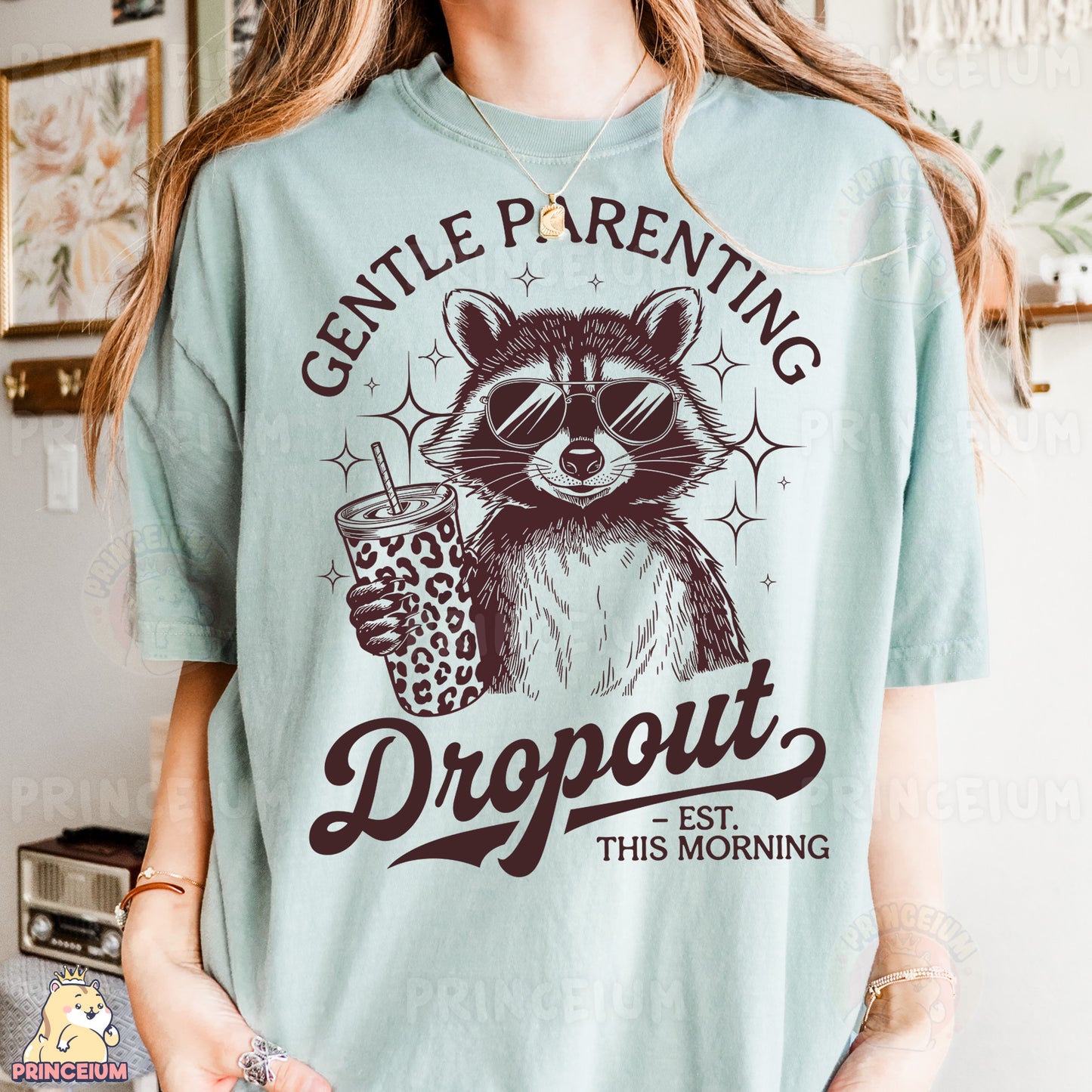 a woman wearing a blue shirt with a raccoon holding a drink